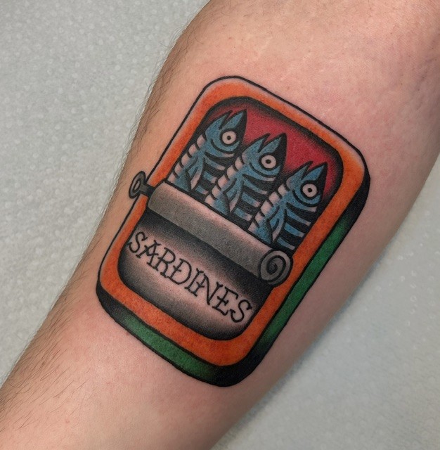 American Traditional sardine tin tattoo on a forearm